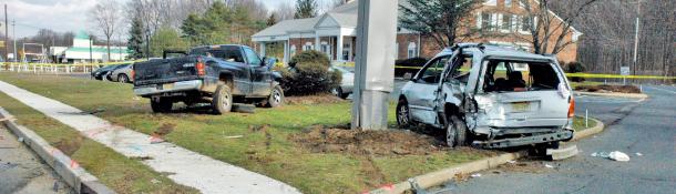 Two crashed cars on the side of the road