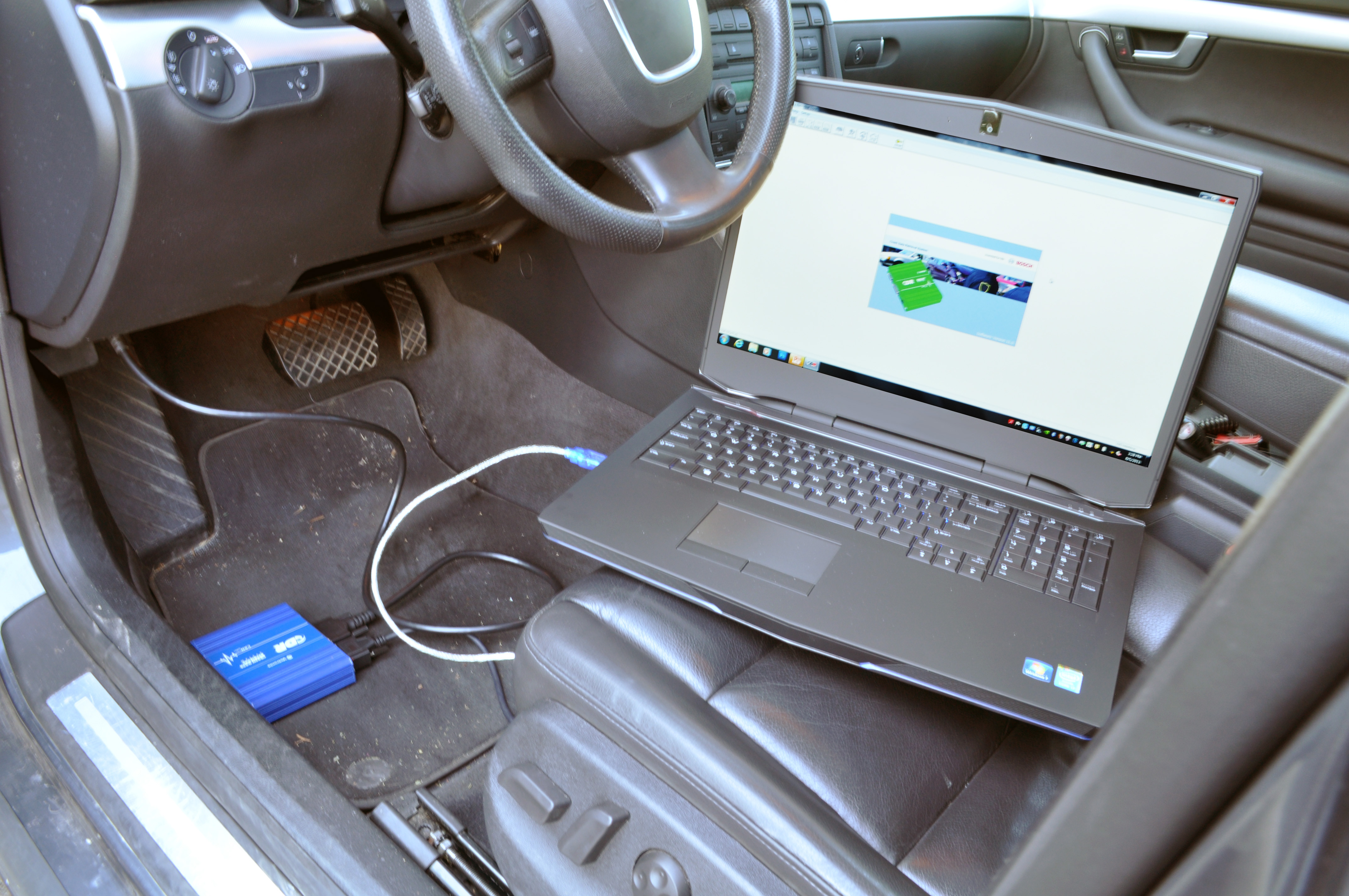 A laptop sitting on a car sear